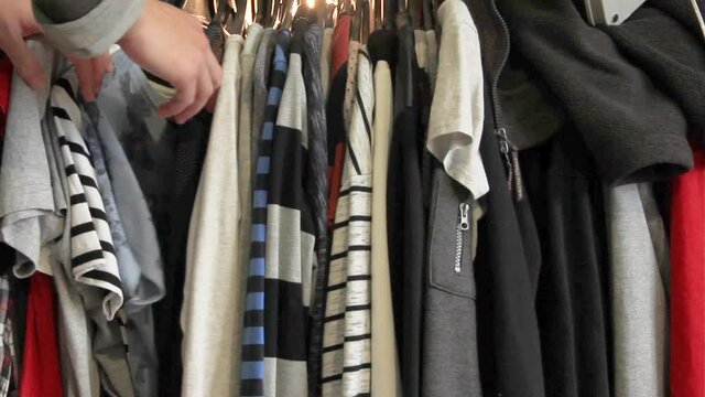 Clothes hanger. Guy chooses clothes