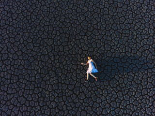 drone view on woman on dry lake