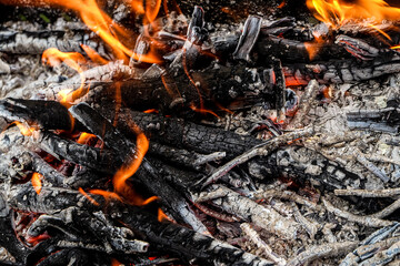 Fire twigs. Burning charcoal in the grill.