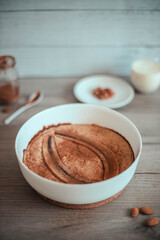 Banana cake with almonds and cinnamon on a wooden table. Vertical photo orientation