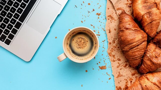 Coffee and croissants for messy breakfast in business office, cinemagraph
