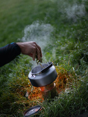 The tourist kettle boils on the stove. travel and a healthy lifestyle
