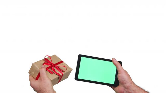 Christmas gift jumps out of the tablet to mans hand. Shopping christmas gifts on tablet. Online shopping concept. 4K stop motion animation isolated on white background. 