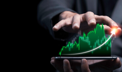 Economic and profit investment growth concept , Businessman holding smartphone with colourful graph.