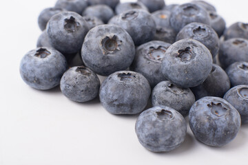 Berry background. Fresh berry blueberries on a white background. Concept of healthy and diet food. Flat lay, top view, Ripe blueberries with copy space for text, shallow DOF