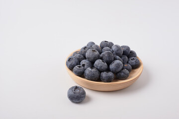 Berry background. Fresh berry blueberries on a white background. Concept of healthy and diet food. Flat lay, top view, Ripe blueberries with copy space for text, shallow DOF