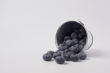 Berry background. Fresh berry blueberries on a white background. Concept of healthy and diet food. Flat lay, top view, Ripe blueberries with copy space for text, shallow DOF