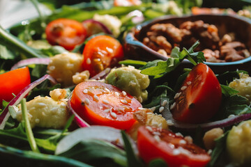 Close-up of salad with avocado, cherry tomatoes, and arugula