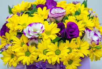 Close up beautiful bright colorful bouquet with yellow chrysanthemum and purple eustoma flowers 