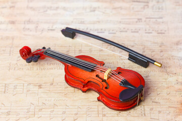 Fototapeta premium miniature violin on a beautiful music background 