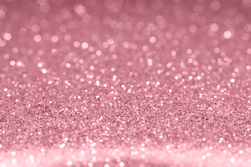 Rose gold christmas glitter background. Shallow depth of field, blurred bokeh effect.