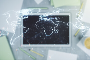 Multi exposure of abstract graphic world map and modern digital tablet on background, connection and communication concept