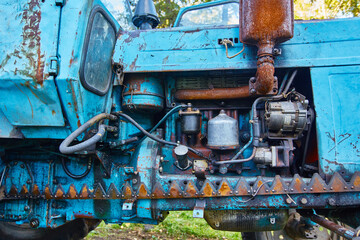 Old tractor engine in oil stains and rust background.