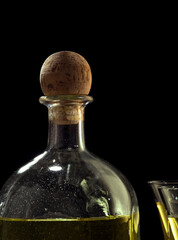 fragment view of bottle of tequila anejo and glasses on black background
