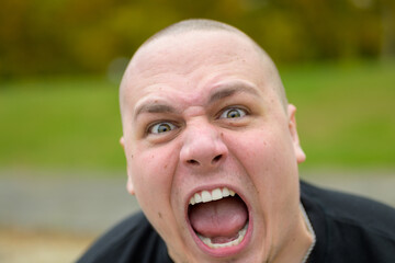 Young man yelling at the camera in frustration