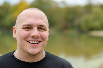 Happy young man laughing at the camera