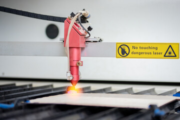 Laser CNC cutting wood. Modern machine industrial technology