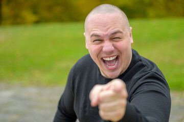 Young man laughing or shouting at the camera