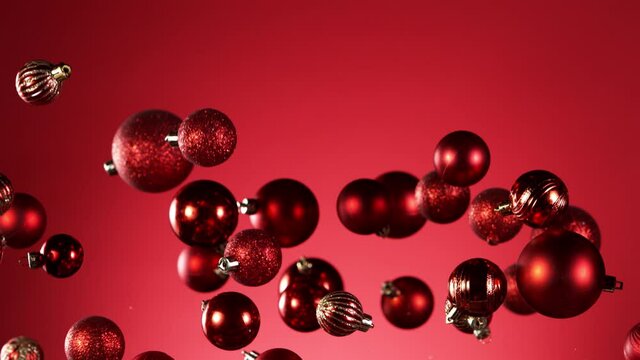 Super slow motion of flying christmas balls isolated on colored background. Filmed on high speed cinema camera, 1000 fps.