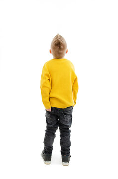Back view of little boy looking at wall. Rear view. Isolated on white background 
