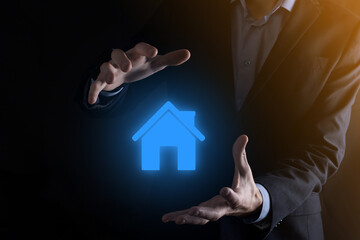 Real estate concept, businessman holding a house icon.House on Hand.Property insurance and security concept. Protecting gesture of man and symbol of house.