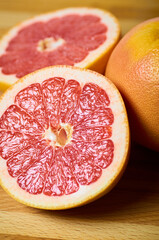 juicy grapefruit slices close up on a board vertically