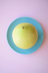 Creative placed pomelo on a pastel background. Flat lay. Minimal food concept.