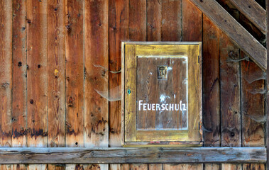 Wooden fire protection casing in an old barn with cobwebs in Tirol, Austria