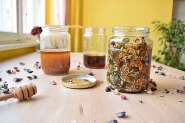 Homemade recipe for immunity, honey with seeds in the jar, on a kitchen table.  Healthy food lifestyle.