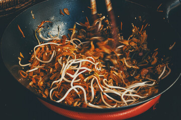 stew with noodles and vegetables in a wok