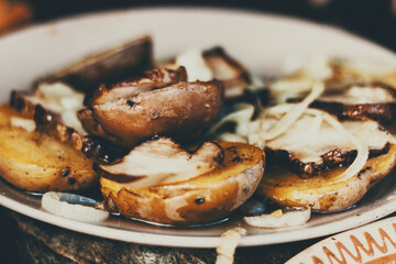 unpeeled potatoes with bacon on the grill