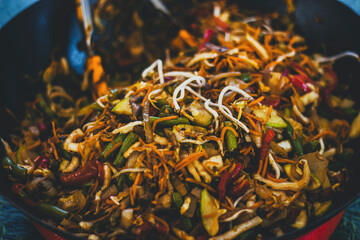 stew with noodles and vegetables in a wok