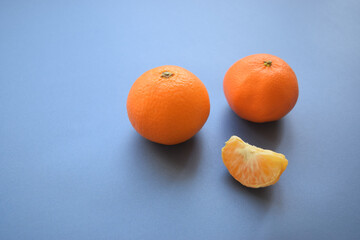 Creative minimal arrangement of tangerine on royal blue background. Modern concept.