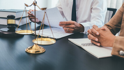 Judge gavel with Justice lawyers having team meeting at law firm background. Concepts of Law and...