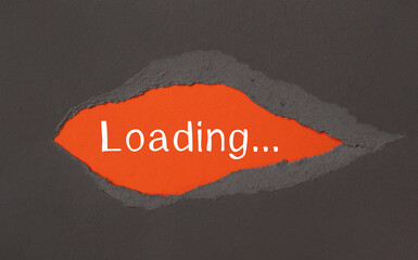LOADING - appearing behind torn paper.