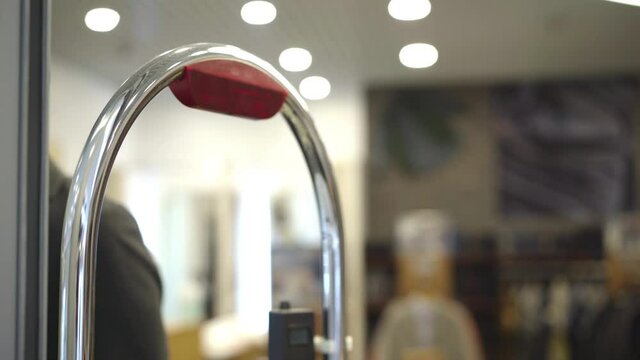 Flashing lights on shoplifting scanner in shopping mall. Concept of security in marts and stores. Anti-theft security systems.