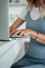 Cozy workplace in home office with laptop on a table for online