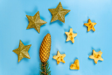 Christmas cookies in the form of stars and New Year's toys stars on a blue background.