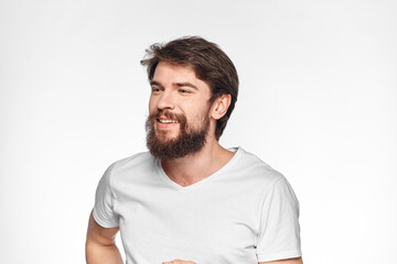 Obraz premium cheerful emotional bearded man gesturing with his hands close-up light background