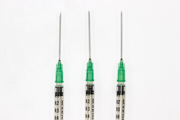 Hypodermic needles on a white background. Shringes for vaccination during the coronavirus pandemic