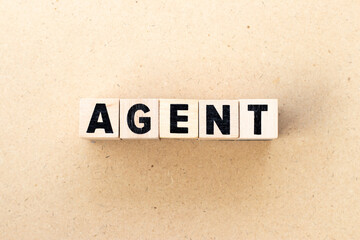 Obraz premium Alphabet letter block in word agent on wood background
