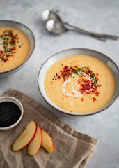 Parsnip cream soup on grey background food photography