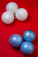 Christmas decorations on a red background. Holiday decorations. Christmas concept. White and blue Christmas balls