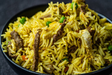 Asian Lemon Rice - South Indian Turmeric Basmati Rice Garnished with Meat, Curry and Saffron / Chitranna Close up Macro View.