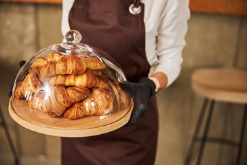 Fresh pastry in the bakery under the glass lid