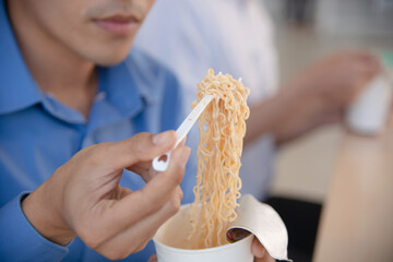office worker enjoy his cup noodle