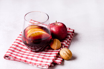 Glass of Delicious Mulled Wine with Orange Apple and Spices Christmas Beverage Light Gray...