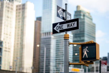 One way road sign (pedestrian signal) and traffic light in NYC