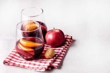 Two Glasses of Delicious Mulled Wine with Orange Apple and Spices Christmas Beverage Light Gray...