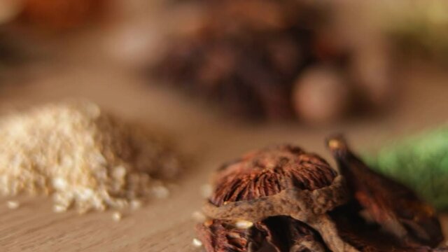 Group of indian spices and herbs difference ware on Wooden teblet,Different spices in spoons on table,Indian bay leaf, Garam masala, Mace, Javitri, Nutmeg, Jaiphal, Star Anise,